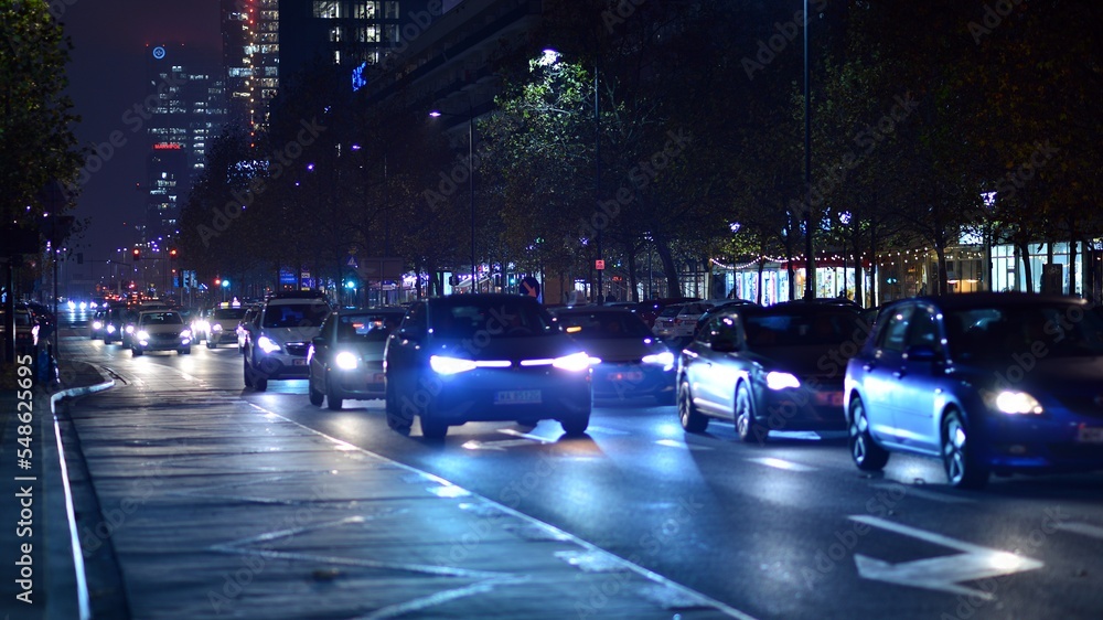 Fototapeta premium Evening city life in the centre. Cars on street. City street lights at night.