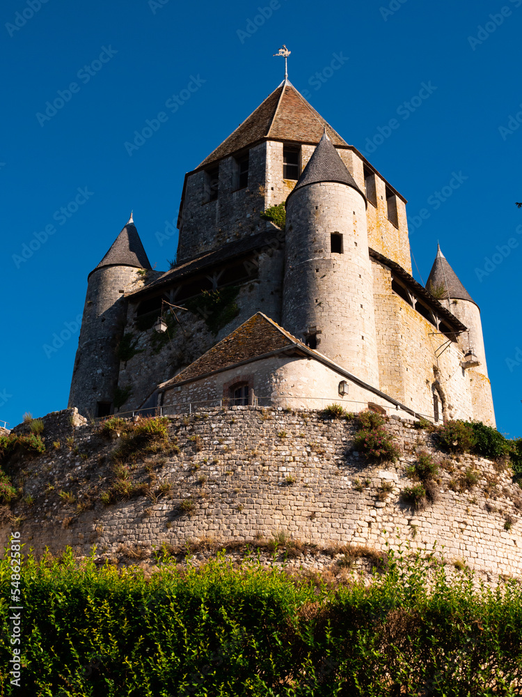 External low angle view of Caesar Tower over deep blue sky. Provins, France.