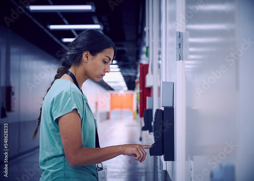 Woman using digital fingerprint scanner in office photo