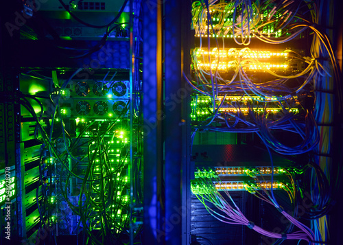 Illuminated network cables in server room photo