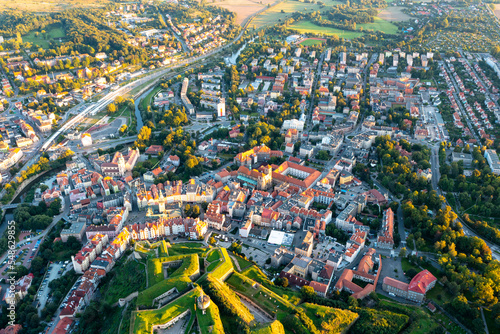 Panorama of the old town of Klodzko from above, beautiful cityscape at sunset and red tiled roofs