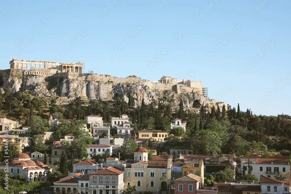Picturesque view of cityscape with beautiful houses and acropolis on sunny day