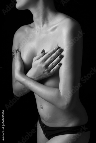 young slender woman posing topless