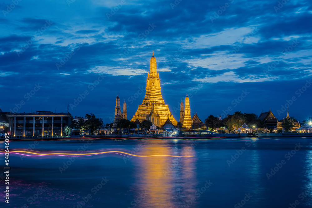 wat arun pagoda on Chao Phraya river bank at late evening with twilight sky