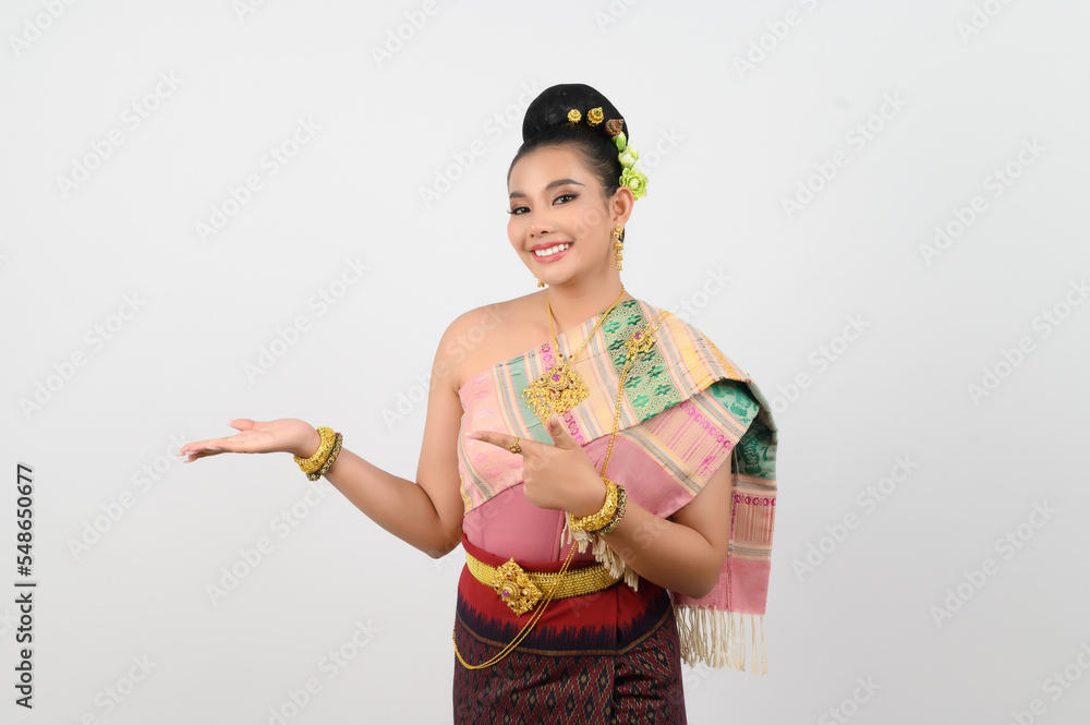 Young beautiful woman in northeastern dress stand and open palm posture Young beautiful woman in northeastern dress stand and open palm posture