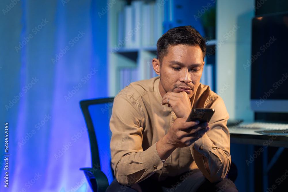 Overtime work concept, Handsome asian business man working late at night in office workplace. Overtime work concept, Handsome asian business man working late at night in office workplace.