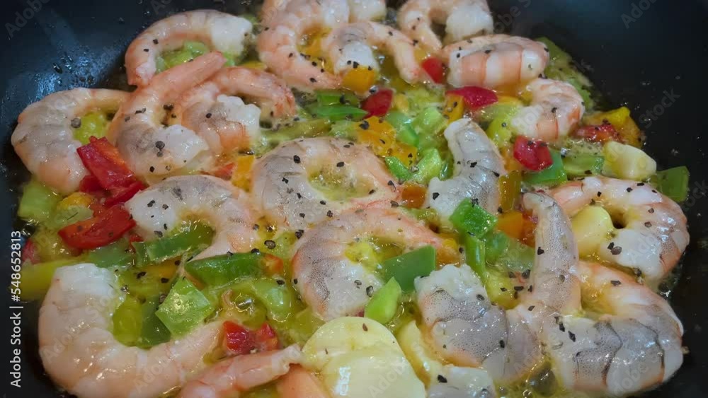 Tiger prawns or shrimps fried in a frying pan with vegetables, garlic and spices close-up. High quality 4k footage with slow motion Tiger prawns or shrimps fried in a frying pan with vegetables, garlic and spices close-up. High quality 4k footage with slow motion