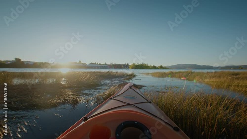 Pov of front of kayak moving through water, ocean