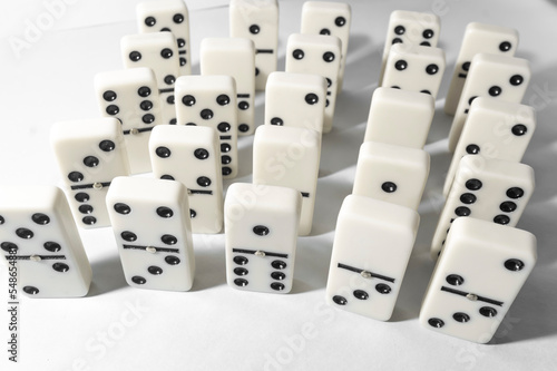 Domino pieces with white background  copy space and various agulos  concept of table games