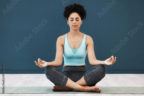 Meditation, yoga and zen of a black woman in a wellness and health studio for mindfulness. Workout, praying and holistic exercise of an athlete for pilates relax with peace mindset and chakra