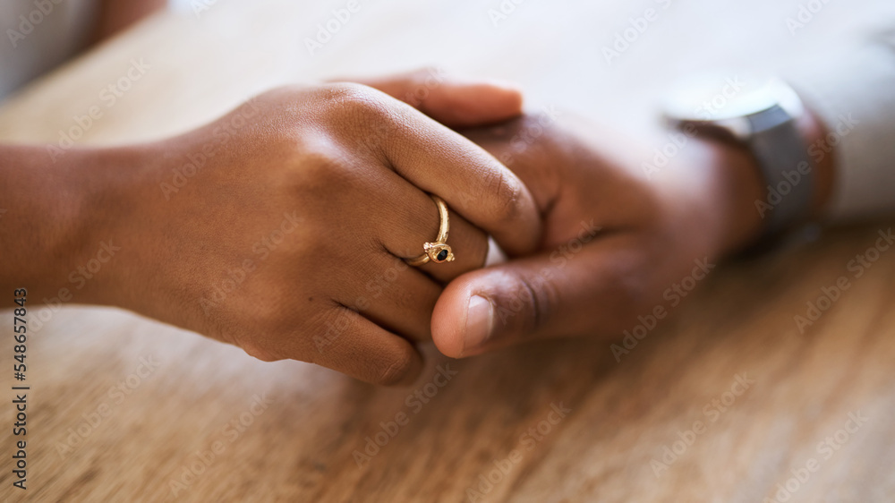 Holding hands, support and trust with couple and love, solidarity, comfort and care with hands zoom against wood table. Partnership, marriage and relationship, helping hand and commitment closeup. Holding hands, support and trust with couple and love, solidarity, comfort and care with hands zoom against wood table. Partnership, marriage and relationship, helping hand and commitment closeup.