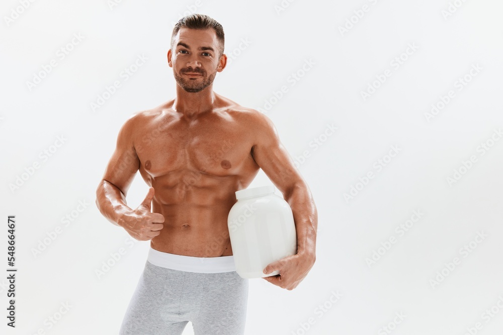 Man bodybuilder boxer with naked torso with abs holding a can of muscle growth pills, steroids, doping, protein. Advertising, sports, active lifestyle, competition, challenge concept. Man bodybuilder boxer with naked torso with abs holding a can of muscle growth pills, steroids, doping, protein. Advertising, sports, active lifestyle, competition, challenge concept.