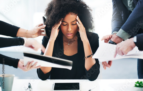 Black woman, headache or stress with office documents for attorney issue with chaos of people. Lawyer, stressed or sick at workplace desk from burnout, anxiety and corporate career challenge. photo