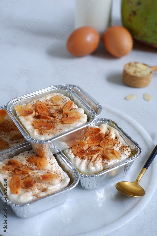 homemade coconut custard cake topped with almond slices and cinnamon homemade coconut custard cake topped with almond slices and cinnamon