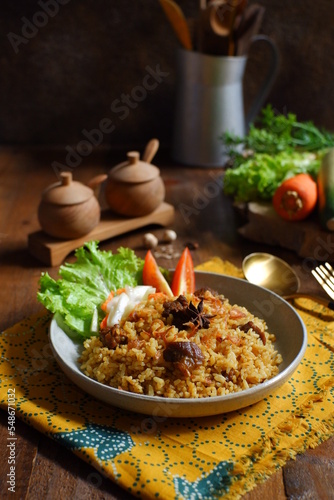 a plate of fried rice with meat 