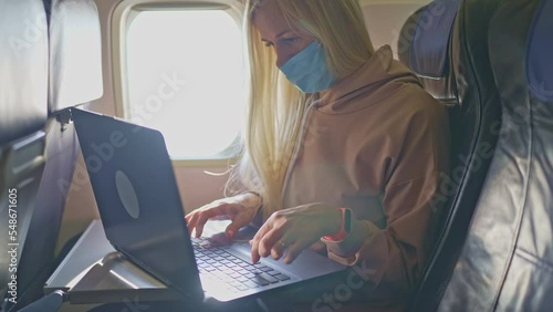 business lady working on a laptop in the cabin. woman reads the news. Emigration problems. war