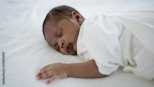 Closeup portrait of african happy baby sleeping sweet dream on bed over white background with copy space. Healthy newborn child take a nap asleep. Family love newborn healthcare medical concept.