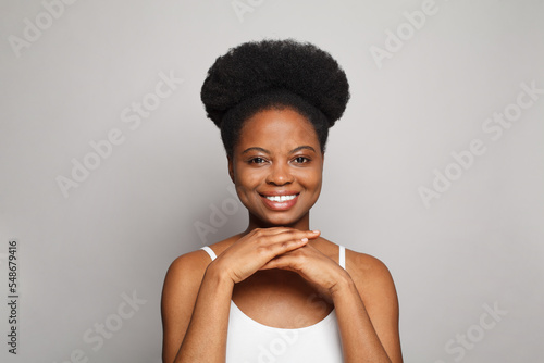 Young smiling woman with perfect fresh clear skin looking at camera on white. Beauty, facial treatment, skin care and cosmetology concept