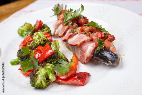 fish in the bacon with vegetables