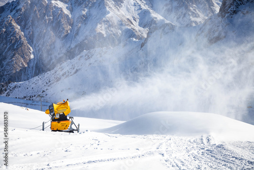 Fotobehang Snow cannon in action at mountain ski resort.