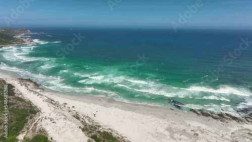 Aerial footage of a vast blue ocean in Platboom Beach, South Africa, in sunny weather photo