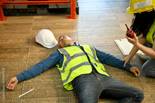 Fotografía Unconscious man pass out while working in the warehouse, recused by a female colleague