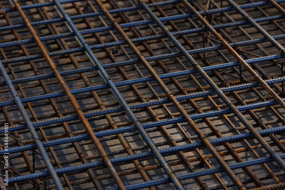 Steel wire mesh piles. BRC welded wire mesh for the construction of floor slabs, supporting frame of a building or monolithic panel. in natural light view from above. Selective focus. pouring concrete Steel wire mesh piles. BRC welded wire mesh for the construction of floor slabs, supporting frame of a building or monolithic panel. in natural light view from above. Selective focus. pouring concrete