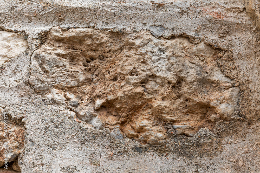 Surface of beige sandy rock. Durable building material and archaeological site. Background. Space for text. Surface of beige sandy rock. Durable building material and archaeological site. Background. Space for text.