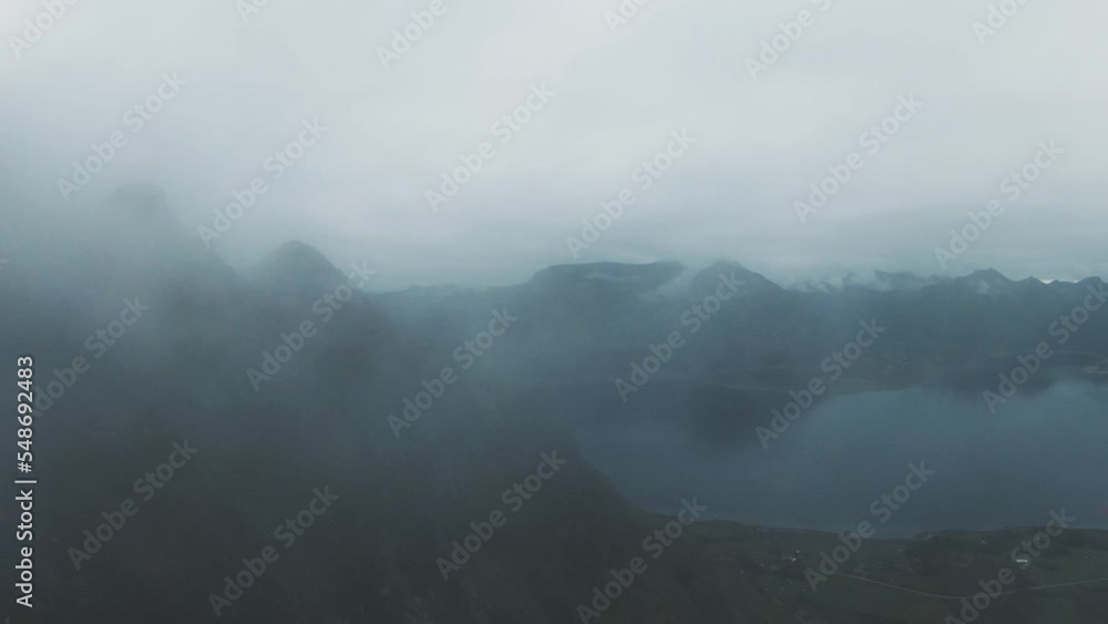 Flying along a mountain starting in the fog. As the fog clears a little you can see the mountains and the ocean in the background, in slowmotion. Flying along a mountain starting in the fog. As the fog clears a little you can see the mountains and the ocean in the background, in slowmotion.