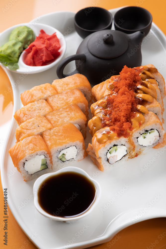 sushi and rolls on an orange background sushi and rolls on an orange background