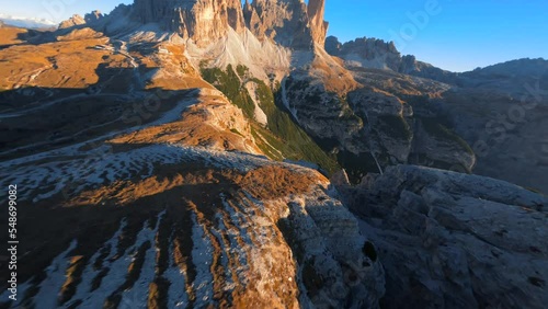 Footage filmed at Rifugio Auronzo, Tri Cine up the mountains in Italian Dolomites. Video of beautifull mountains Tri Cine, filmed at sunrise in 4k with a fpv drone flying smooth with fast movement photo
