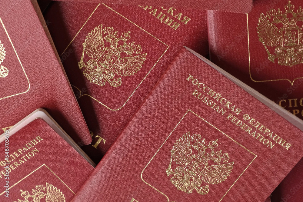 Fototapeta premium Russian Passports. Travel Documents. Foreign Passport. Closeup of National Passport of the Russian Federation. Vacation and tourism concept. High Angle View. Flat Lay.