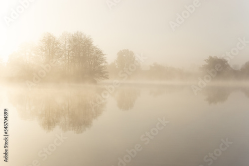 Foggy early morning on a lake.