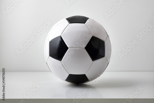 Detail of soccer ball on table and light gray background