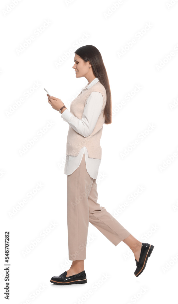 Young woman with smartphone walking on white background Young woman with smartphone walking on white background