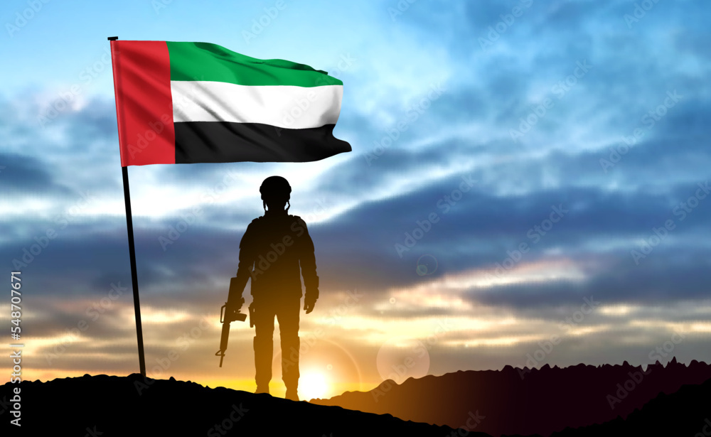 Silhouette of a soldier on background of the sunrise and UAE flag. Armed forces of United Arab Emirates. Concept for Commemoration Day, Martyrs Day