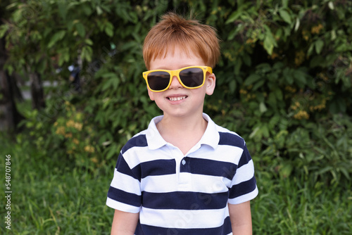 Cute little boy with sunglasses in park