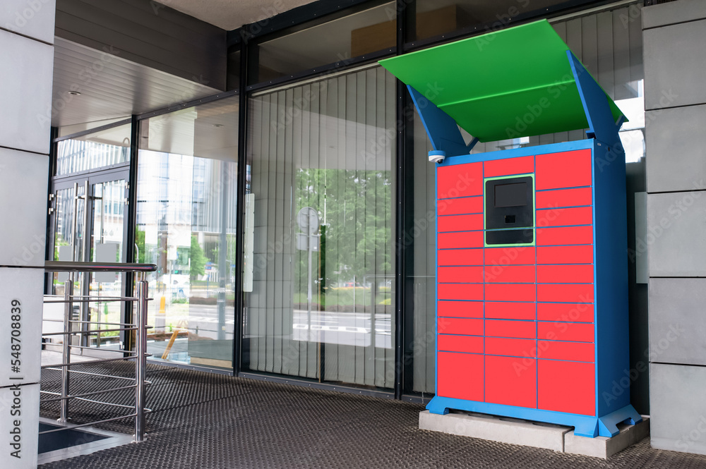 Fototapeta premium Parcel locker with many postal boxes near building outdoors