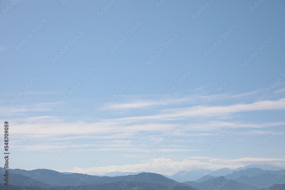 Picturesque view of mountain landscape and blue sky with clouds