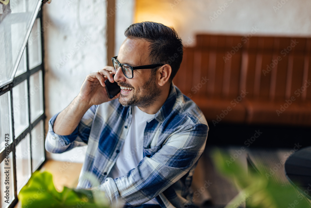 © bnenin - Side view of a businessman making a phone call during the break