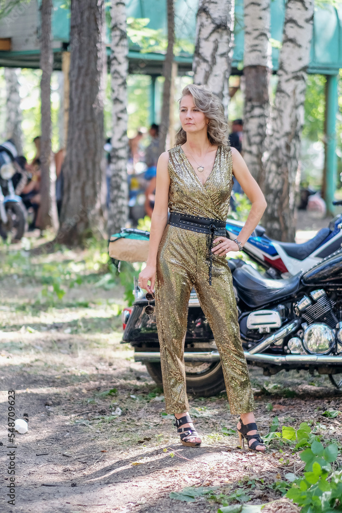 beautiful woman posing in a golden suit. full length portrait of a woman beautiful woman posing in a golden suit. full length portrait of a woman