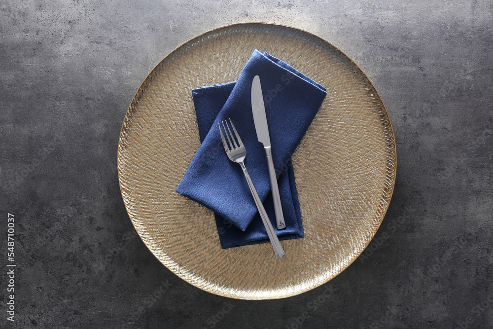 Tray with blue napkins and cutlery on grey table, top view Tray with blue napkins and cutlery on grey table, top view