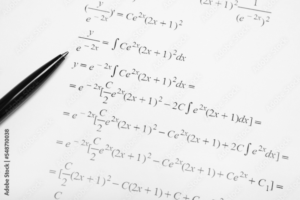 Sheet of paper with mathematical formulas and pen Sheet of paper with mathematical formulas and pen