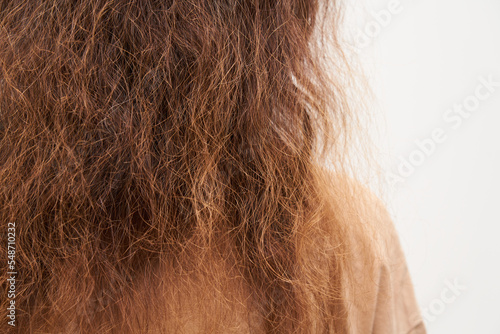 Dry and frizzy natural curly hair that needs hydration. Natural curls before salon treatment. close up.