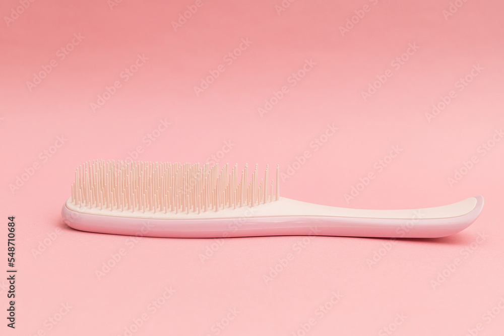 Pink hairbrush on pink background, monochrome Pink hairbrush on pink background, monochrome