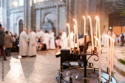 Εκτύπωση καμβά Selective focus on lit candles in a church as people attend the congregation