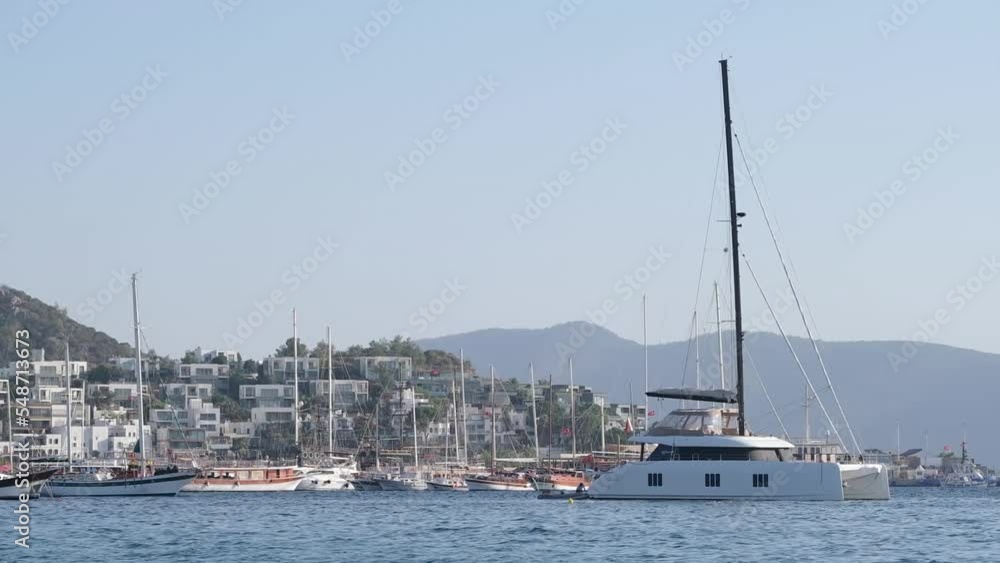 Sailing catamaran is anchored in the sea. Sailing catamaran is anchored in the sea.