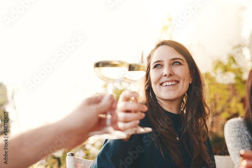 Wine, happy and woman toast in celebration at a party with friends in outdoor restaurant on holiday. Smile, cheers and girl drinking champagne enjoying quality time in summer on vacation in Berlin #548713687