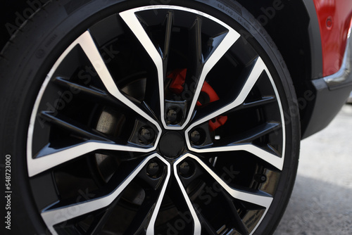 Alloy wheel with calipers and brakes of the car. Brake disc and low profile tyres. Car test driving. Lower-profile tires of cars. High-performance sports cars. © MaxSafaniuk