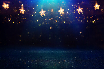 Christmas warm gold garland lights over dark background with glitter overlay